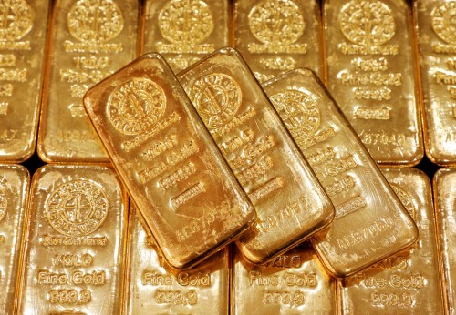 Gold eases on firm dollar, yields as Fed verdict looms