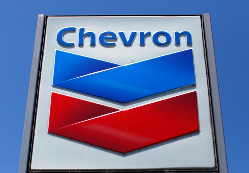 Chevron vows to slow carbon emissions, raise oil output with modest spending