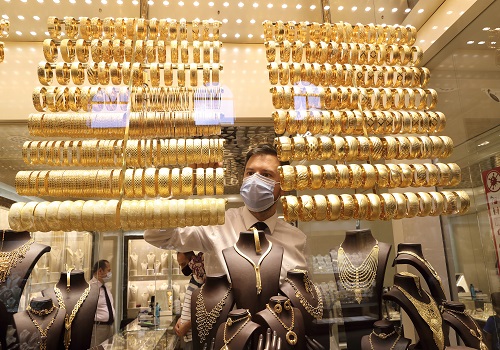 Gold inches lower on dollar uptick; focus on key central bank meetings