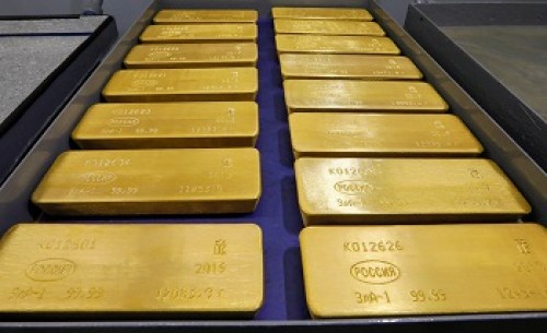 Gold dips as dollar firms on Powell's hawkish tone