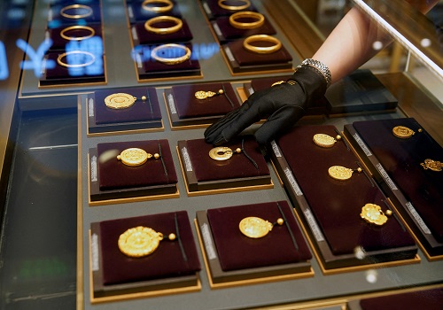 Gold edges down on stronger dollar, market awaits US inflation data